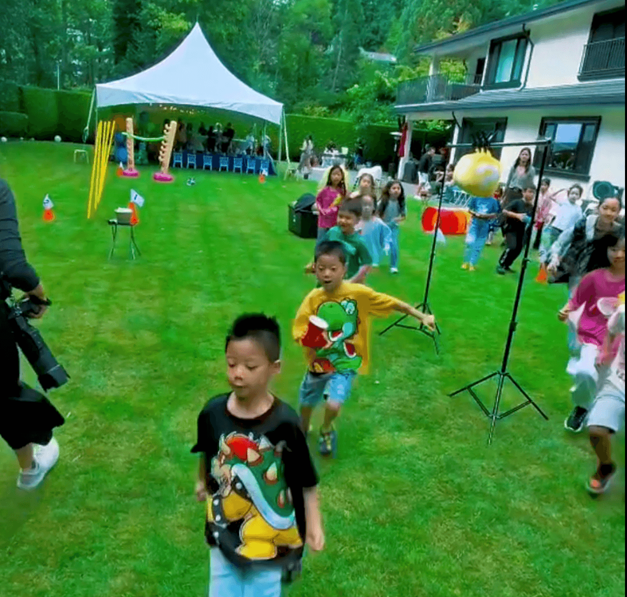 Boys racing across a backyard during a team game at a Vancouver birthday party.